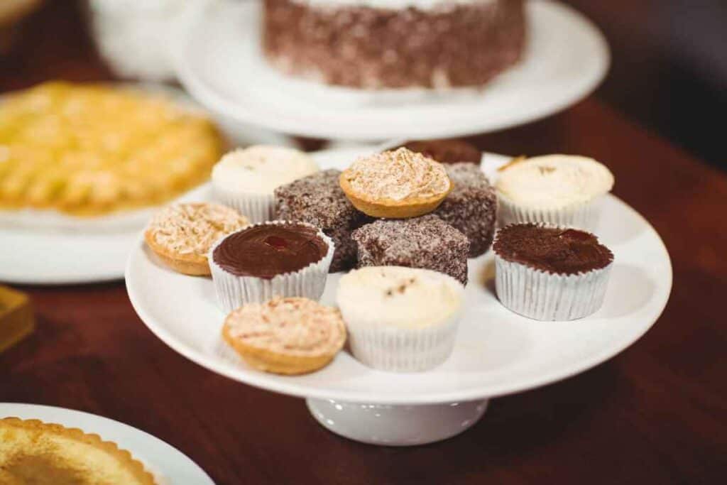 A delectable selection of pastries and cupcakes on a cake stand, showcasing sweet treats typical of the local fare found on Sydney food tours.