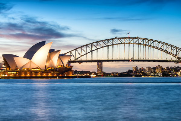 The Sydney Opera house and the Harbour Bridge with blue sky and water in the background for the latitude and longitude of sydney
