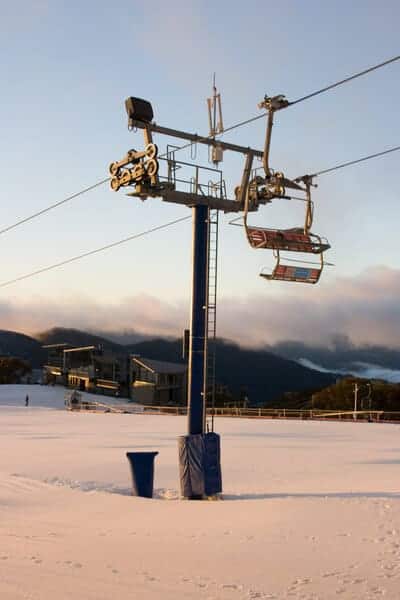 Chairlifts over snow-covered slopes at Mount Buller, a favoured destination for skiing near Melbourne, offering an invigorating experience during the winter season.