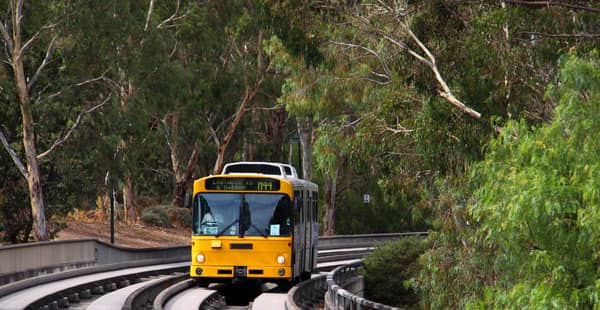 A yellow bus on the streets of Adelaide, illustrating the public transport options available in Australia for the post 'Does Australia Have Good Public Transport?"