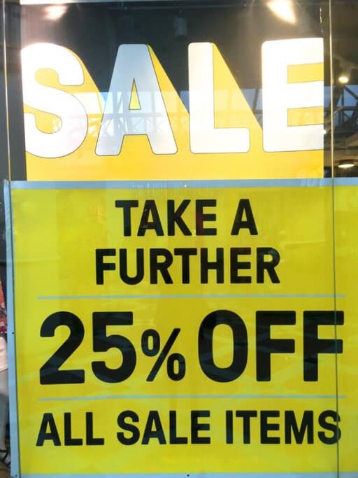 A yellow sale sign advertising an additional 25% off on all sale items, likely for a Boxing Day sale in Australia. This highlights the festive shopping season, which is one of the cool facts about Christmas in Australia, where Boxing Day sales are a major event for scoring big discounts.