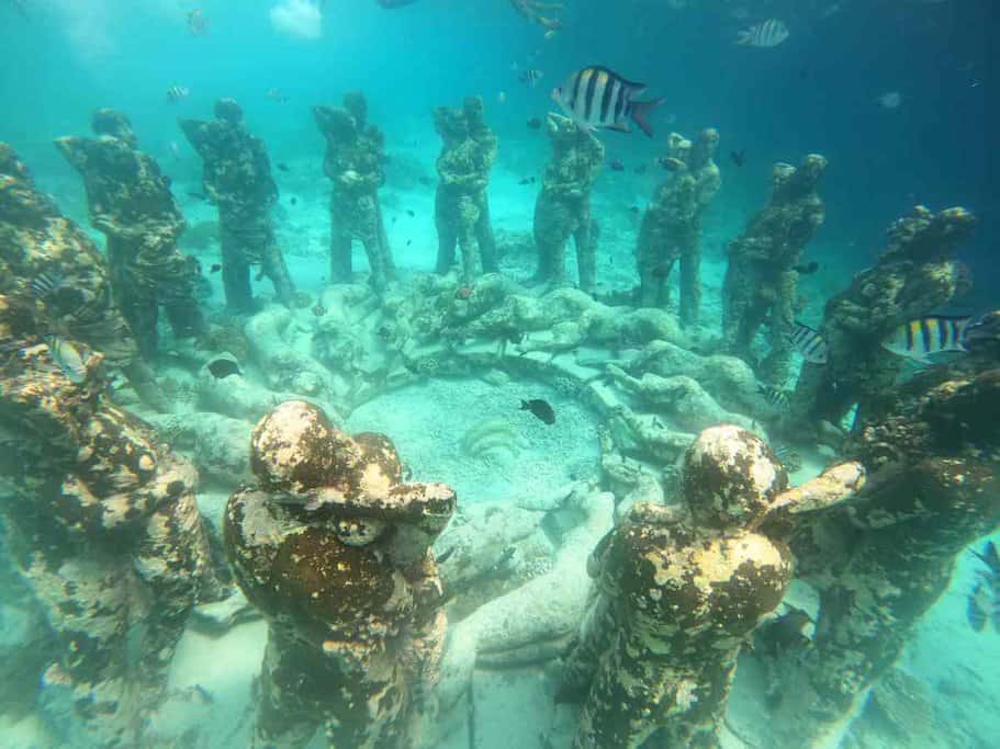 Underwater view of the Nest sculpture at the Gili Meno BioRock reef, surrounded by tropical fish, showcasing the unique snorkelling experiences when travelling to the Gili Islands from Bali.