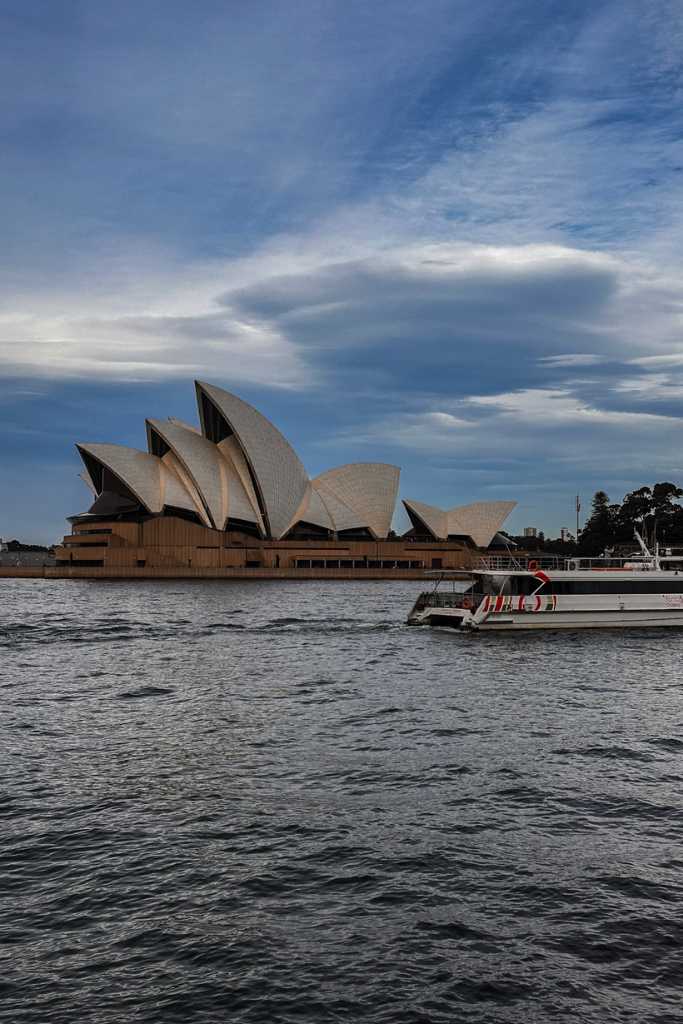 The Sydney Opera House and a boat in the background.